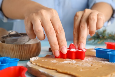 Photo of Woman making Christmas cookies at table, closeup