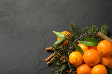Photo of Christmas composition with tangerines on black background, flat lay. Space for text