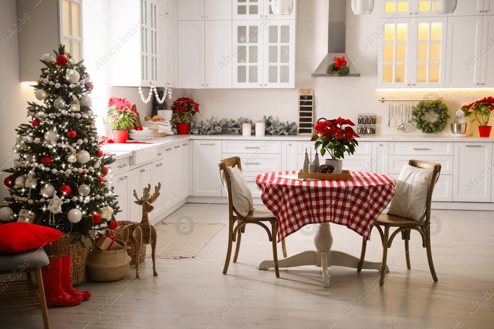 Photo of Beautiful kitchen interior with Christmas tree and festive decor