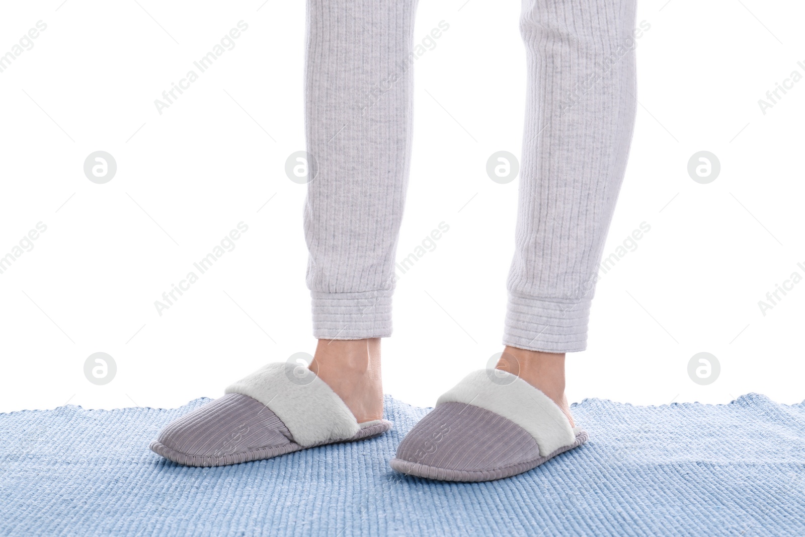 Photo of Woman in warm soft slippers on white background, closeup