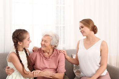 Happy sisters and their grandmother at home