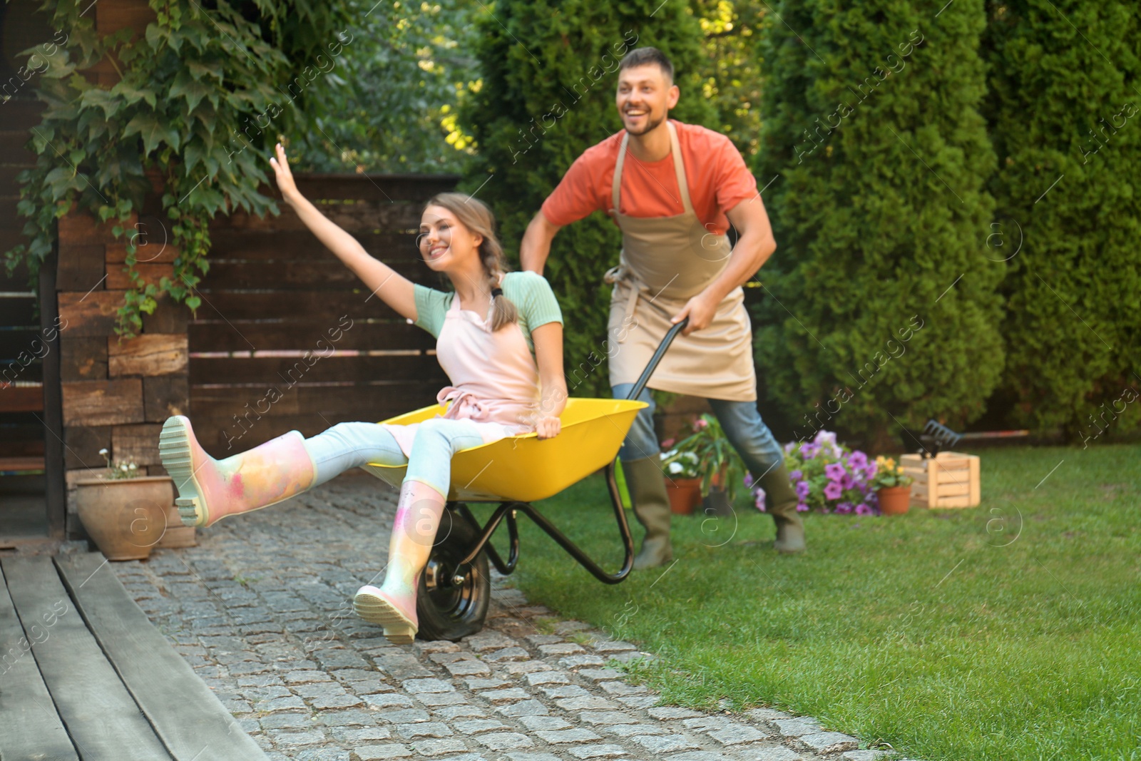 Photo of Happy couple having fun while working together in garden