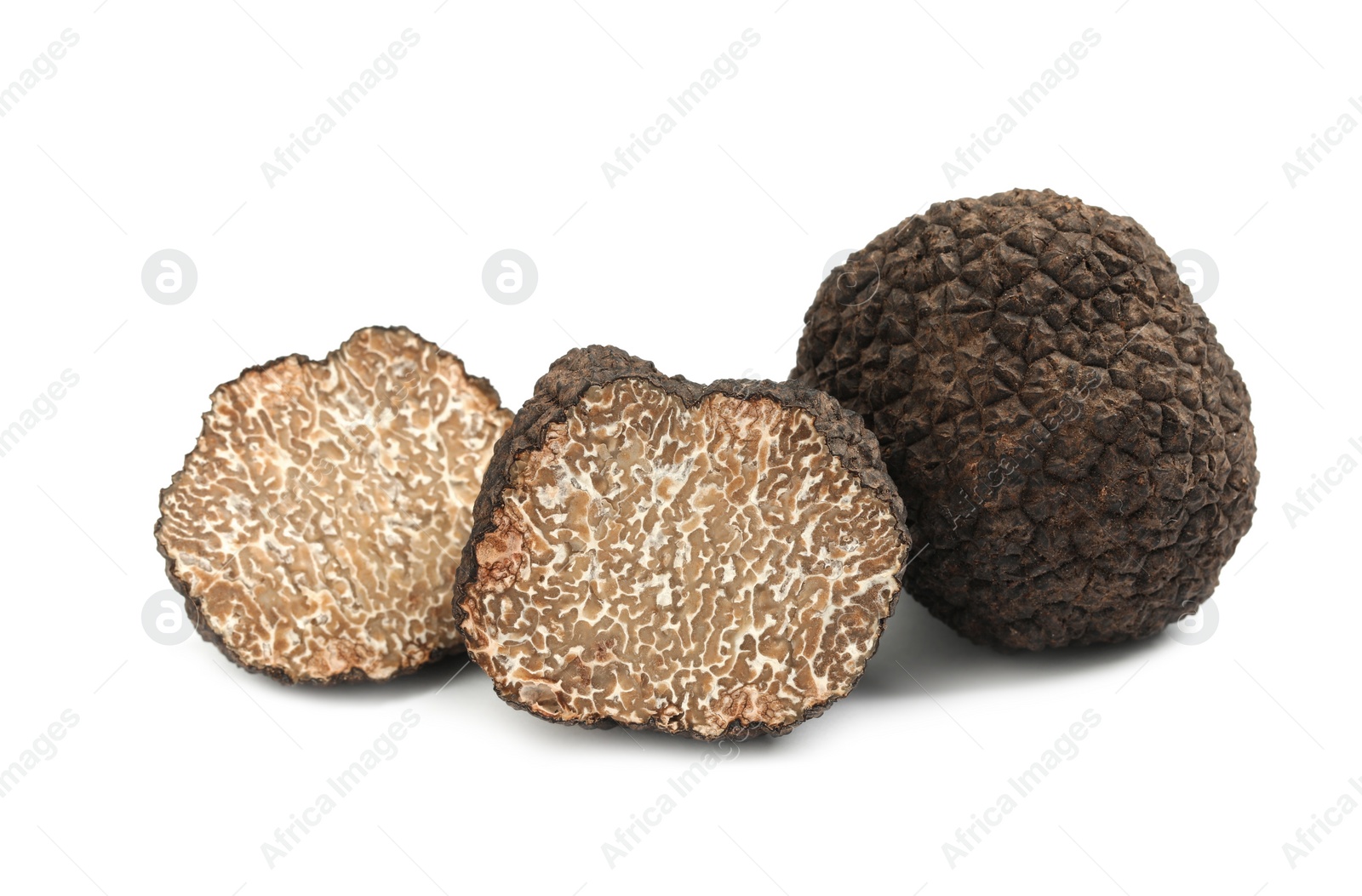 Photo of Cut and whole black truffles isolated on white