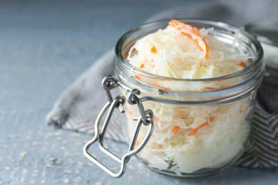 Photo of Tasty homemade fermented cabbage on wooden table, closeup
