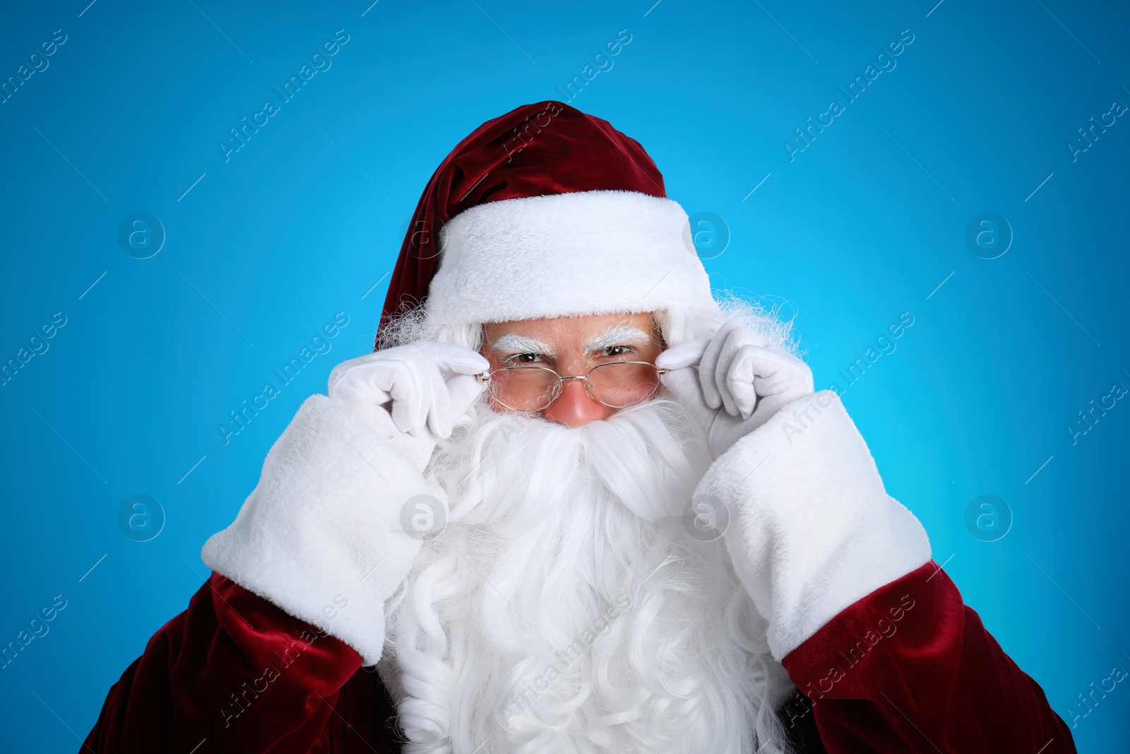 Photo of Portrait of Santa Claus on light blue background