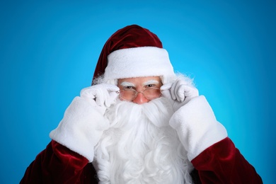 Portrait of Santa Claus on light blue background