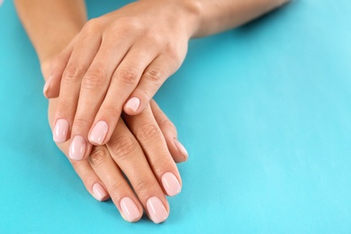 Photo of Closeup view of woman with beautiful hands on color background, space for text. Spa treatment