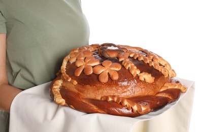 Woman with korovai on white background, closeup. Ukrainian bread and salt welcoming tradition