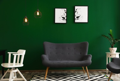 Modern living room interior stylish sofa near green wall