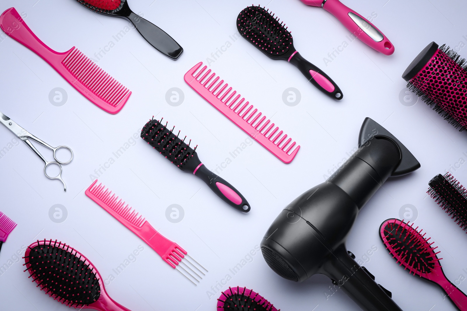 Photo of Flat lay composition with modern hair dryer on white background