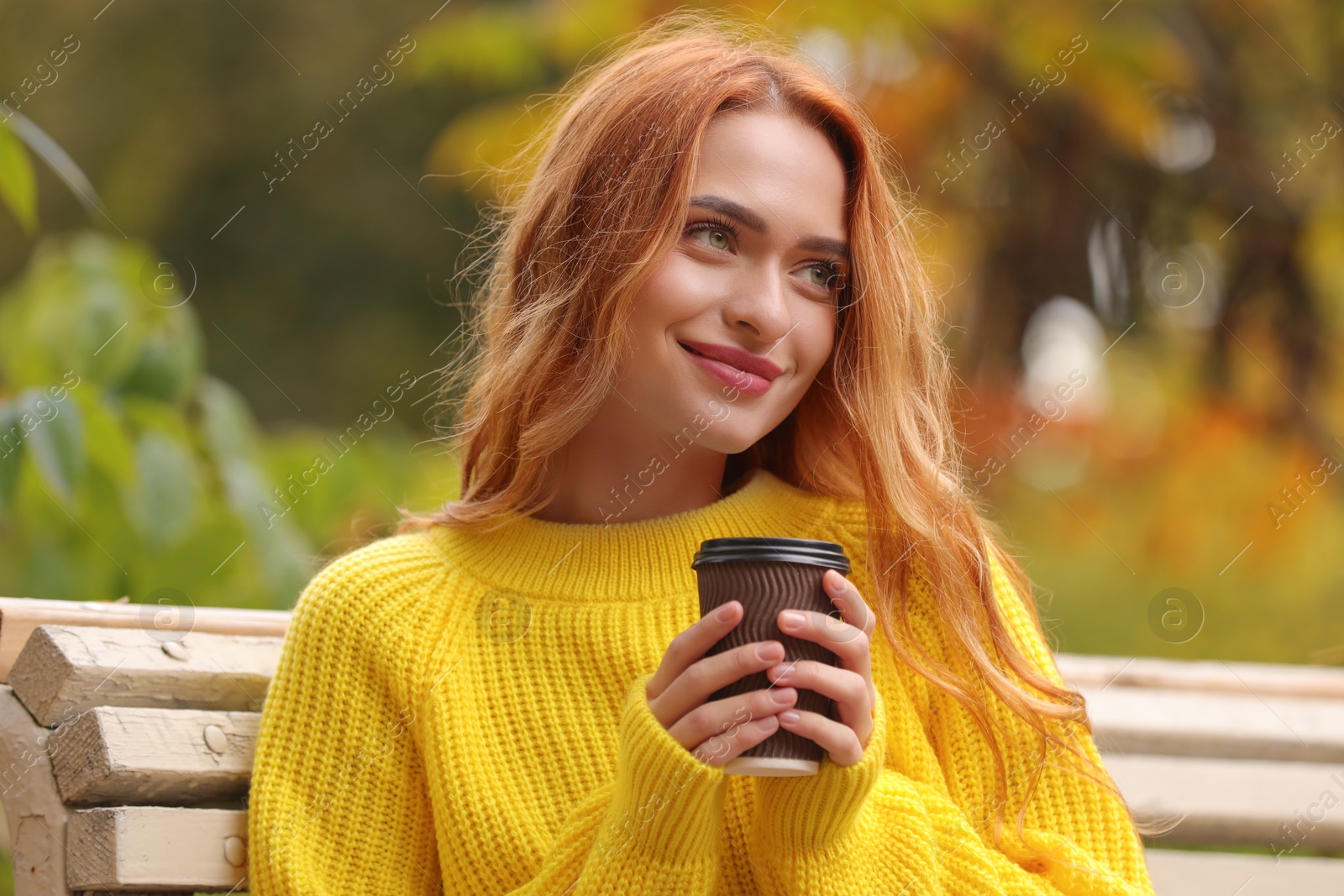 Photo of Portrait of beautiful woman with paper cup enjoying autumn outdoors