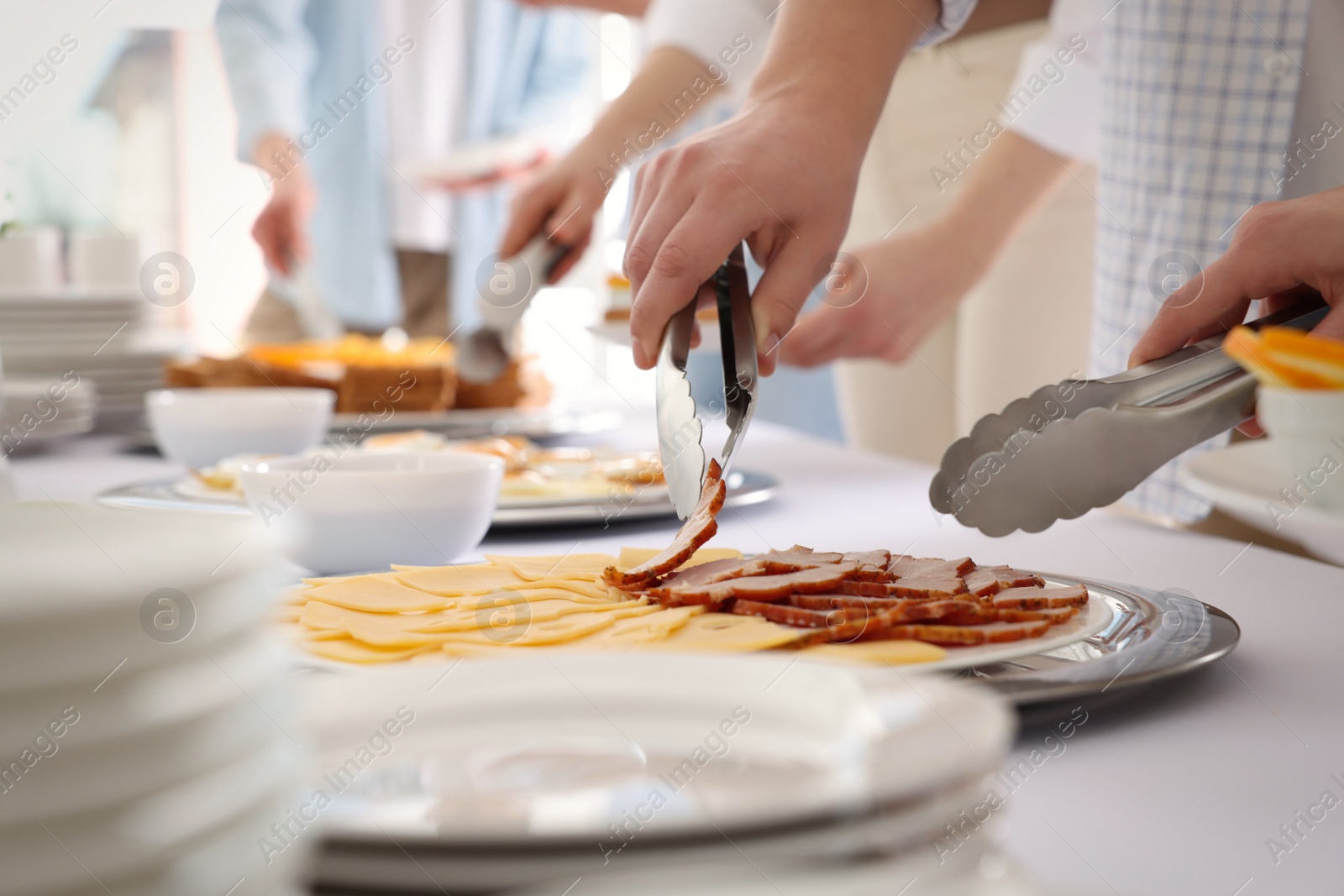 Photo of People taking food during breakfast, closeup. Buffet service