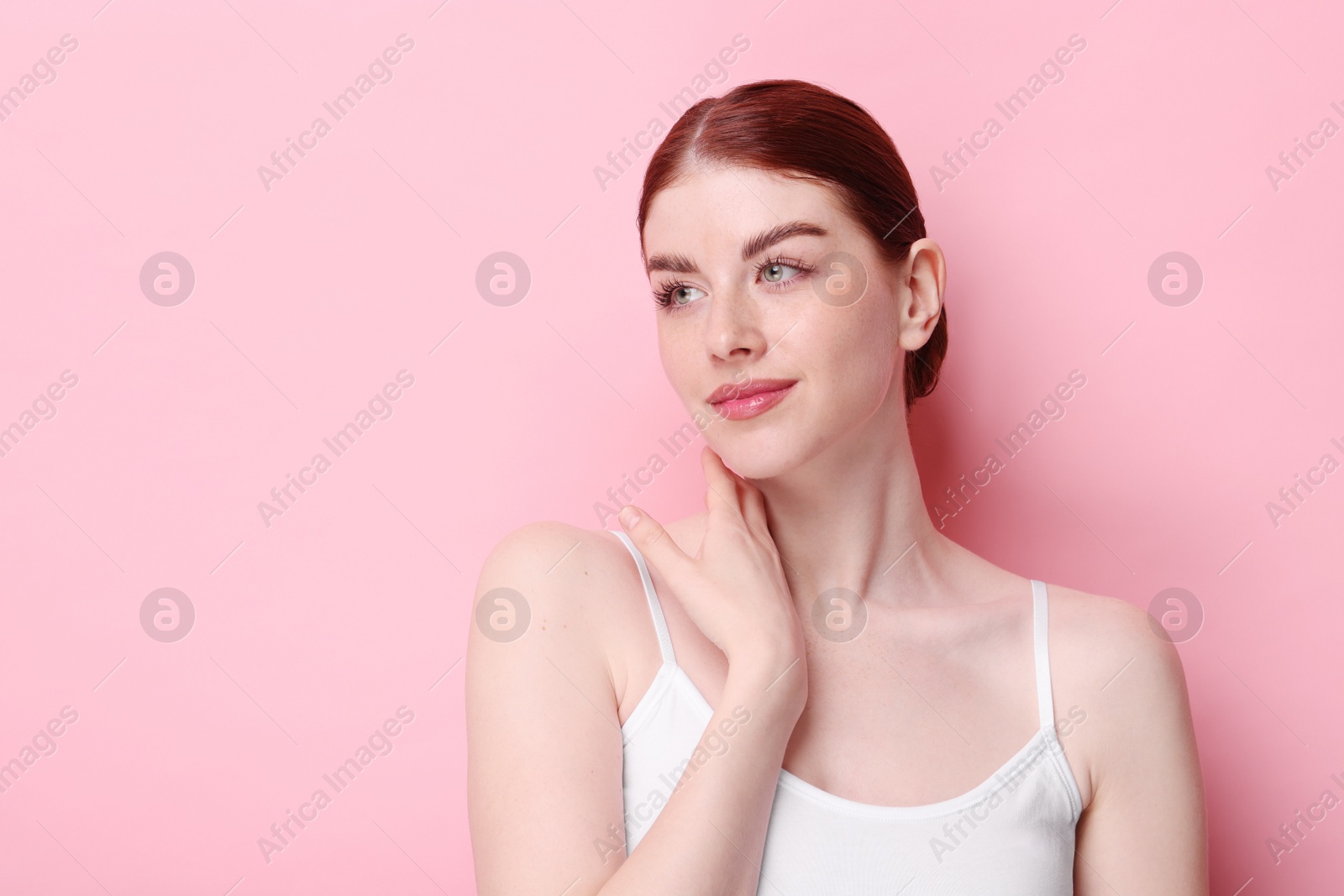 Photo of Portrait of beautiful woman on pink background. Space for text