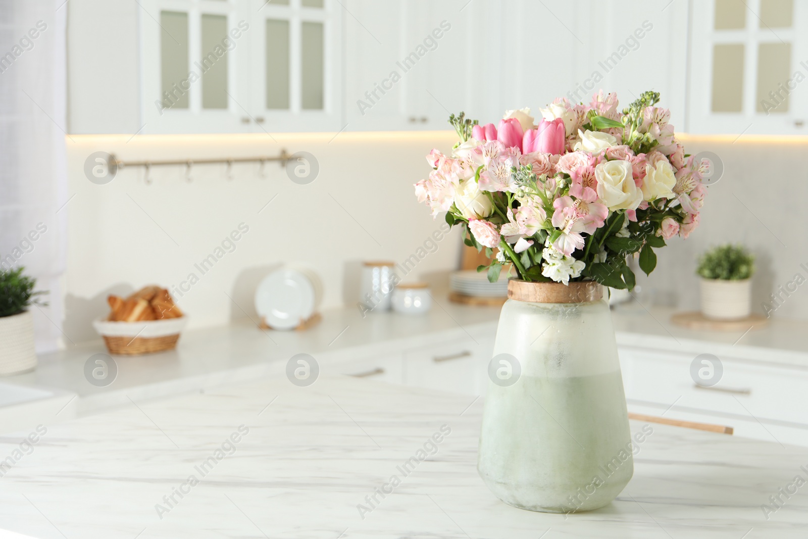 Photo of Beautiful bouquet of fresh flowers in vase on table indoors, space for text