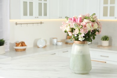 Photo of Beautiful bouquet of fresh flowers in vase on table indoors, space for text