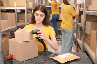 Young post office employees working in warehouse