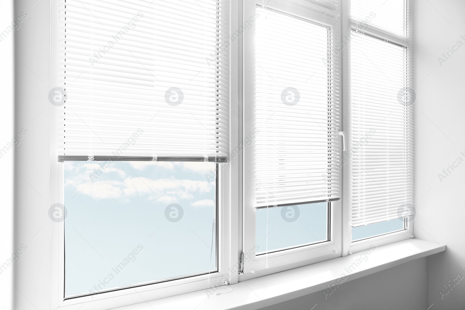 Photo of Stylish window with horizontal blinds in room