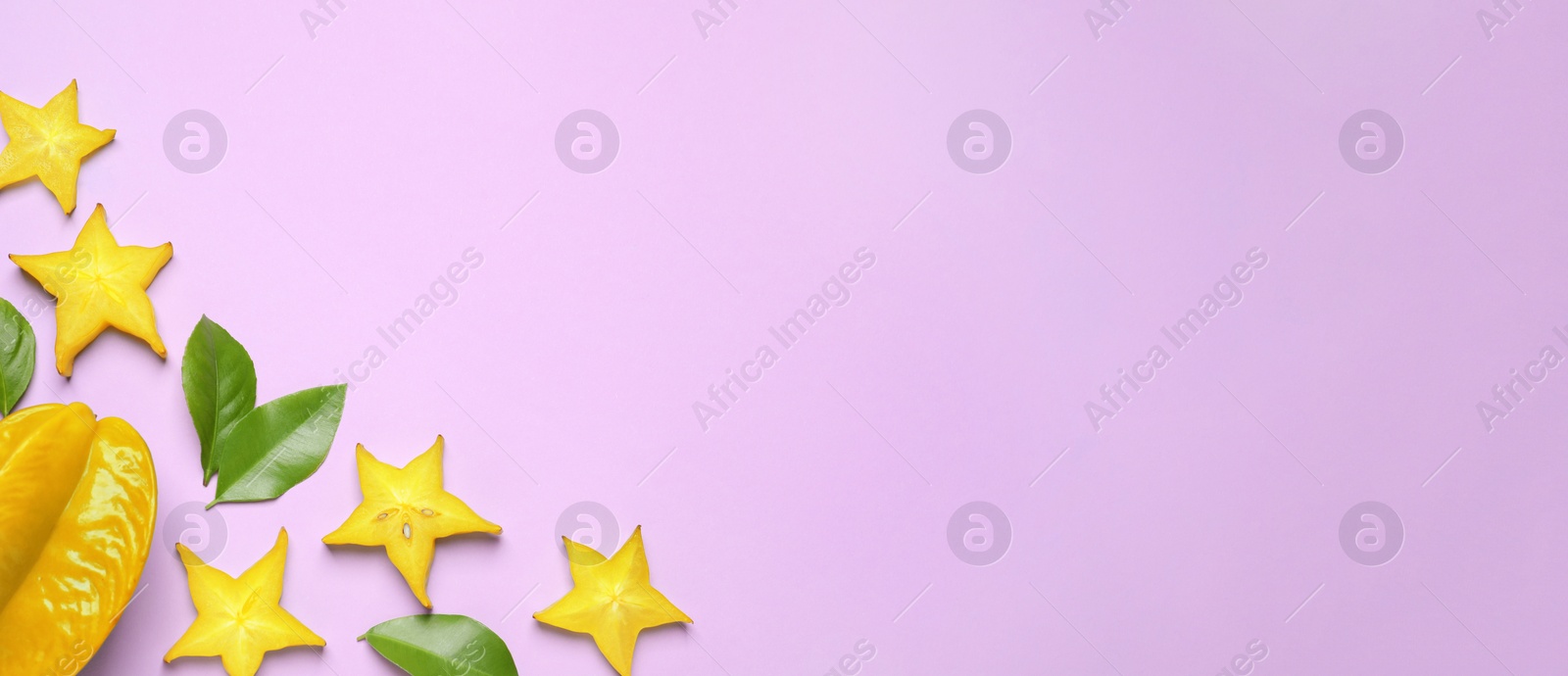Photo of Delicious carambola fruits on violet background, flat lay. Space for text