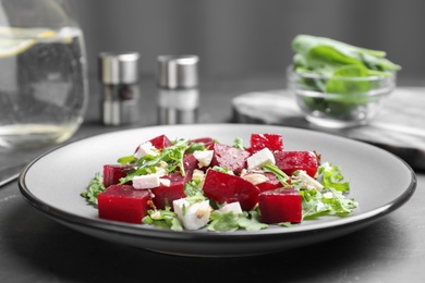 Delicious beet salad served on black table, closeup