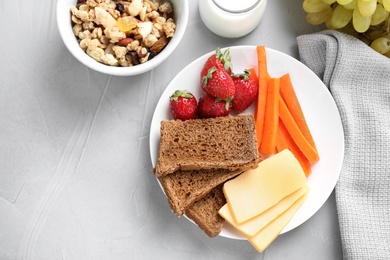 Flat lay composition with healthy breakfast on light grey table
