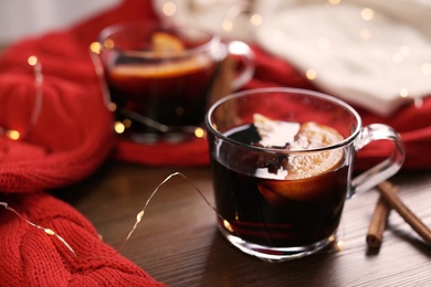 Photo of Beautiful composition with cup of mulled wine on table. Space for text