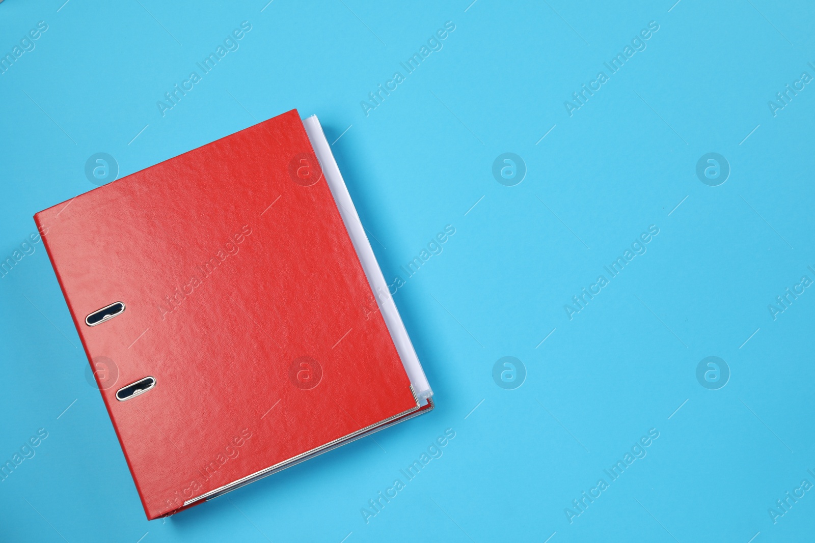 Photo of One office folder on light blue background, top view. Space for text