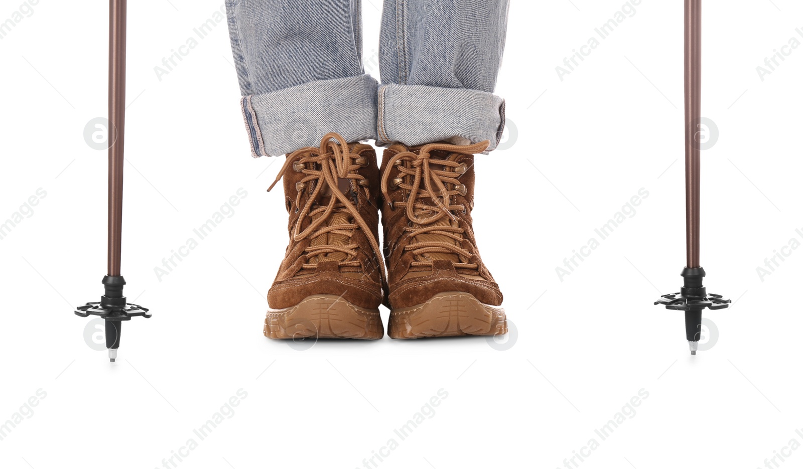 Photo of Woman wearing stylish hiking boots with trekking poles on white background, closeup