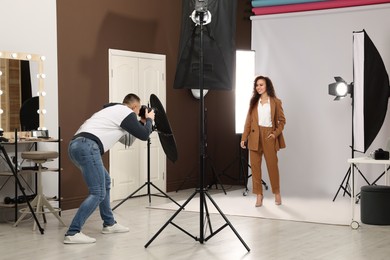 Beautiful African American model posing for professional photographer in studio