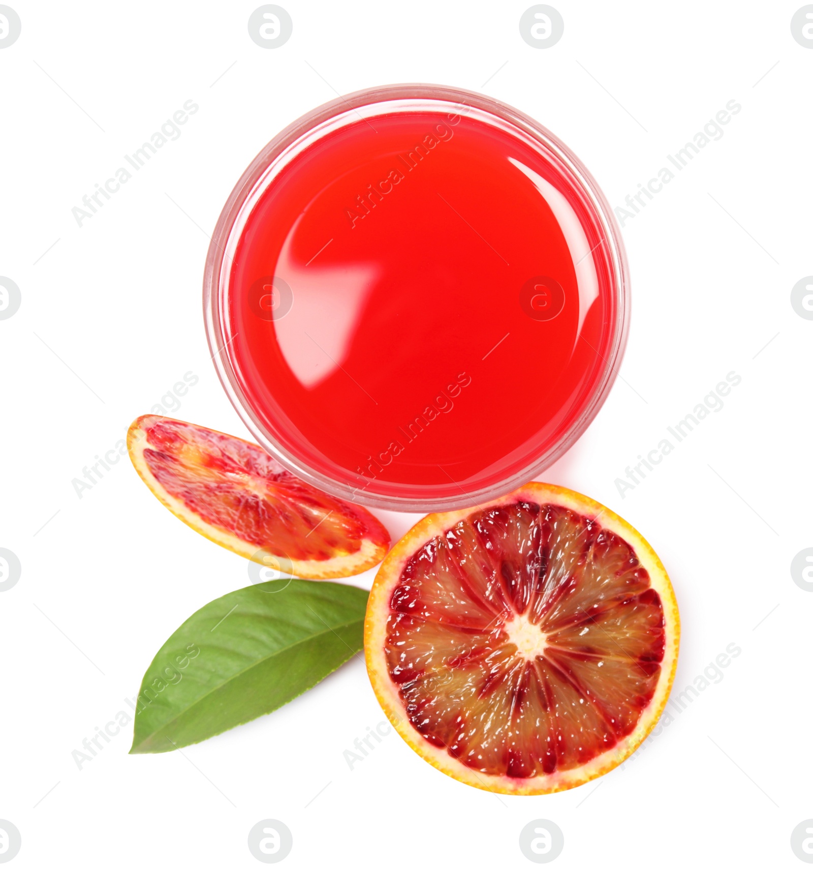 Photo of Tasty sicilian orange juice in glass, fruit and leaf on white background, top view