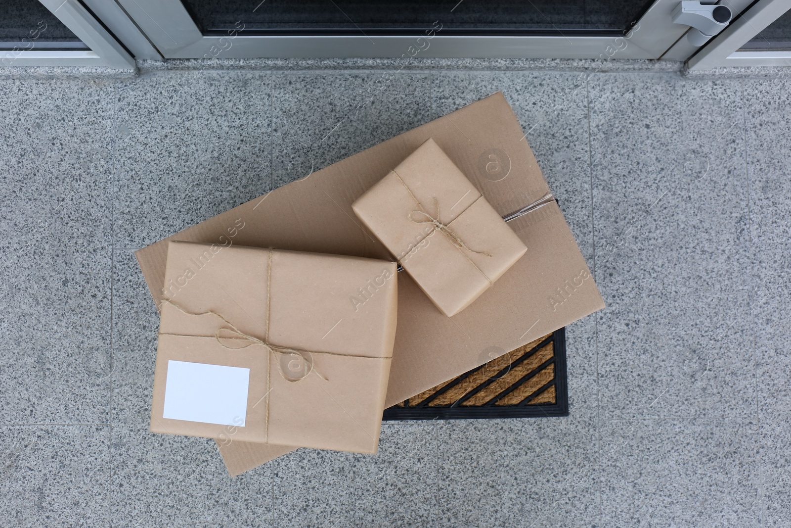 Photo of Delivered parcels on door mat near entrance, top view