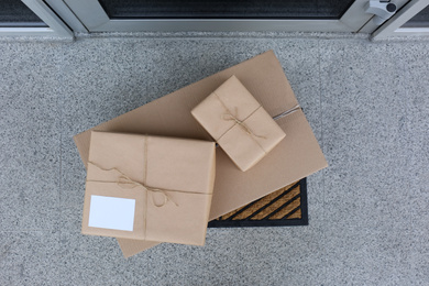Photo of Delivered parcels on door mat near entrance, top view