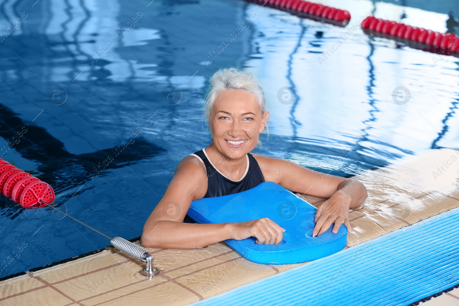 Photo of Sportive senior woman in indoor swimming pool