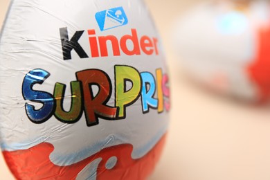 Photo of Slynchev Bryag, Bulgaria - May 25, 2023: Kinder Surprise Egg on blurred background, closeup. Space for text