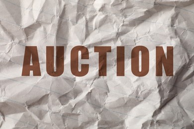 Image of Word Auction on crumpled sheet of paper, closeup view