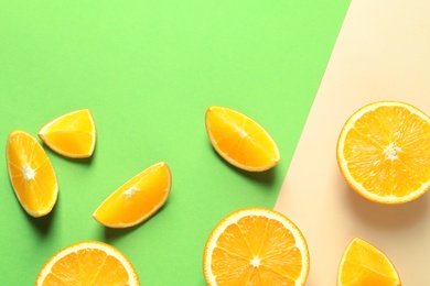 Photo of Flat lay composition with ripe oranges on color background. Space for text