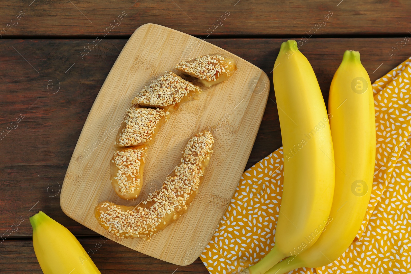 Photo of Delicious fresh and fried bananas on wooden table, flat lay