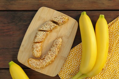 Delicious fresh and fried bananas on wooden table, flat lay