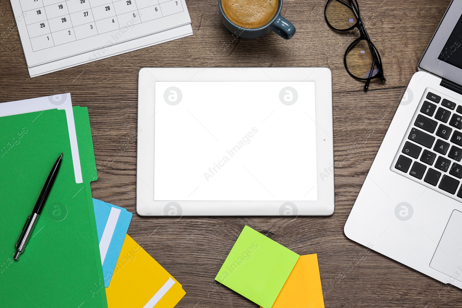 Photo of Modern gadgets, glasses and office stationery on wooden table, flat lay. Distance learning