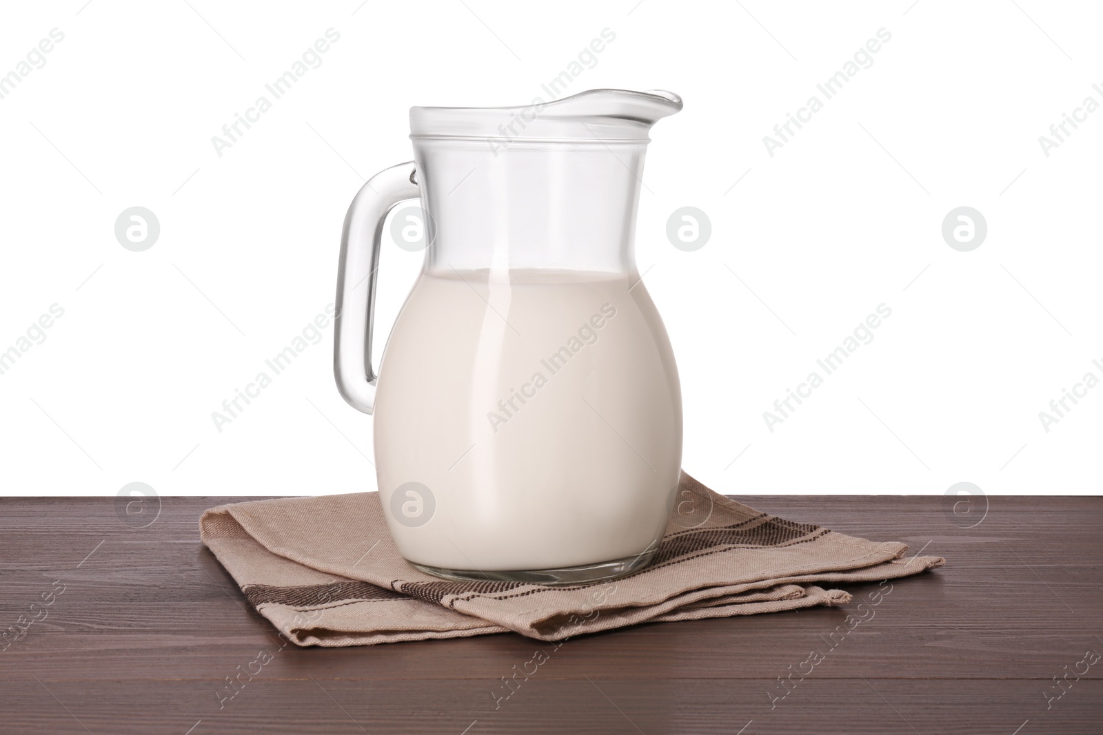 Photo of Jug of tasty milk on wooden table against white background