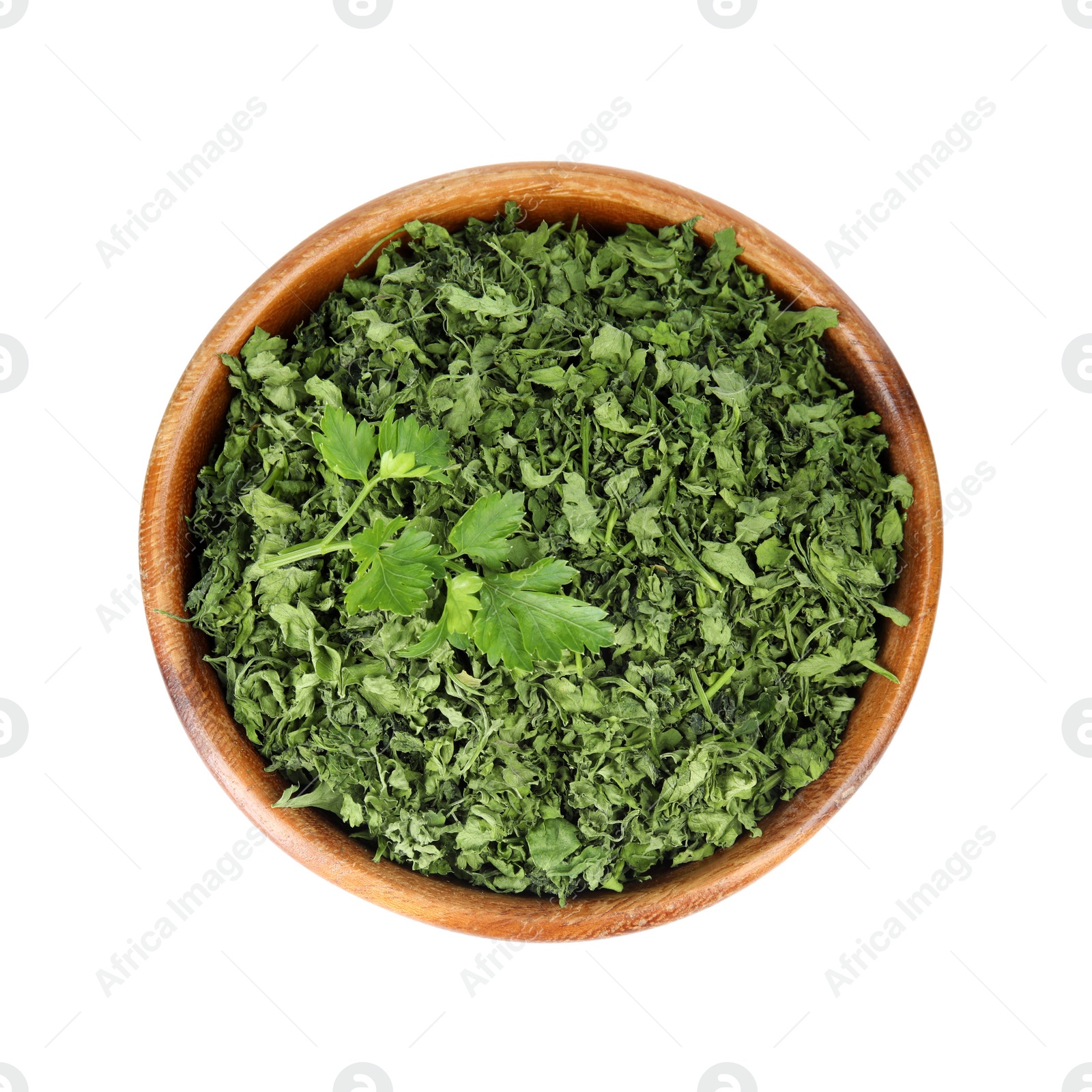 Photo of Bowl with dried parsley and fresh twig on white background, top view