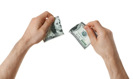 Man with teared dollar bill on white background, closeup