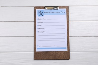 Photo of Medical prescription form with empty fields on white wooden table, top view