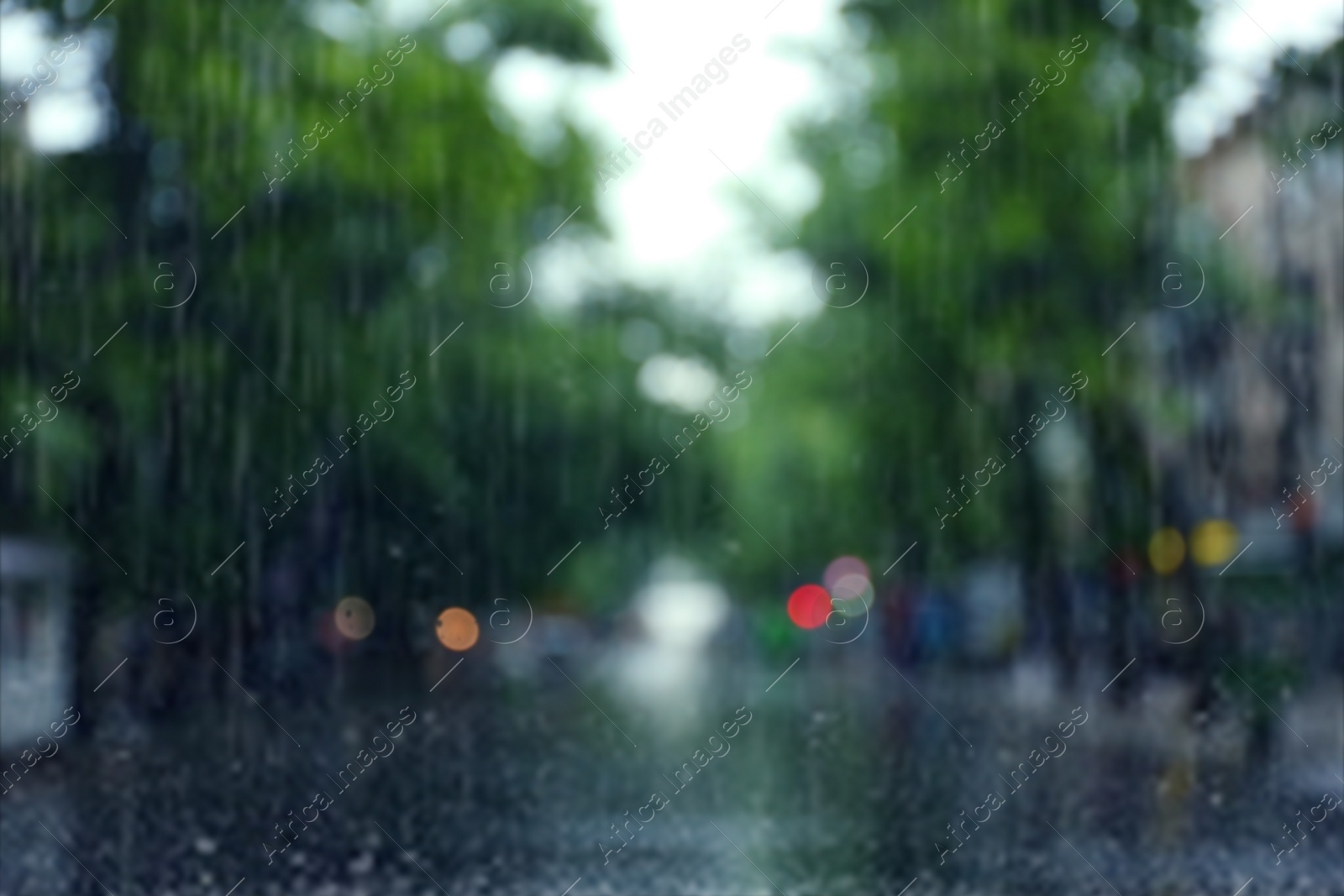Photo of Blurred view of city street on rainy day