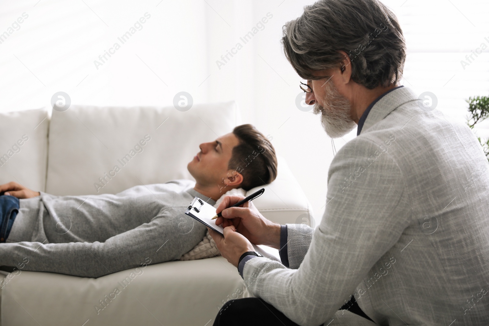 Photo of Psychotherapist and patient in office. Hypnotherapy session