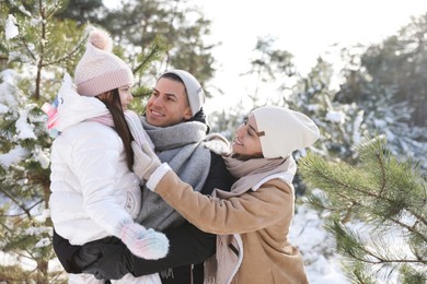 Happy family outdoors on winter day. Christmas vacation