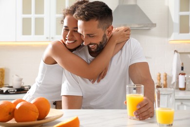 Lovely couple enjoying time together during breakfast at table in kitchen