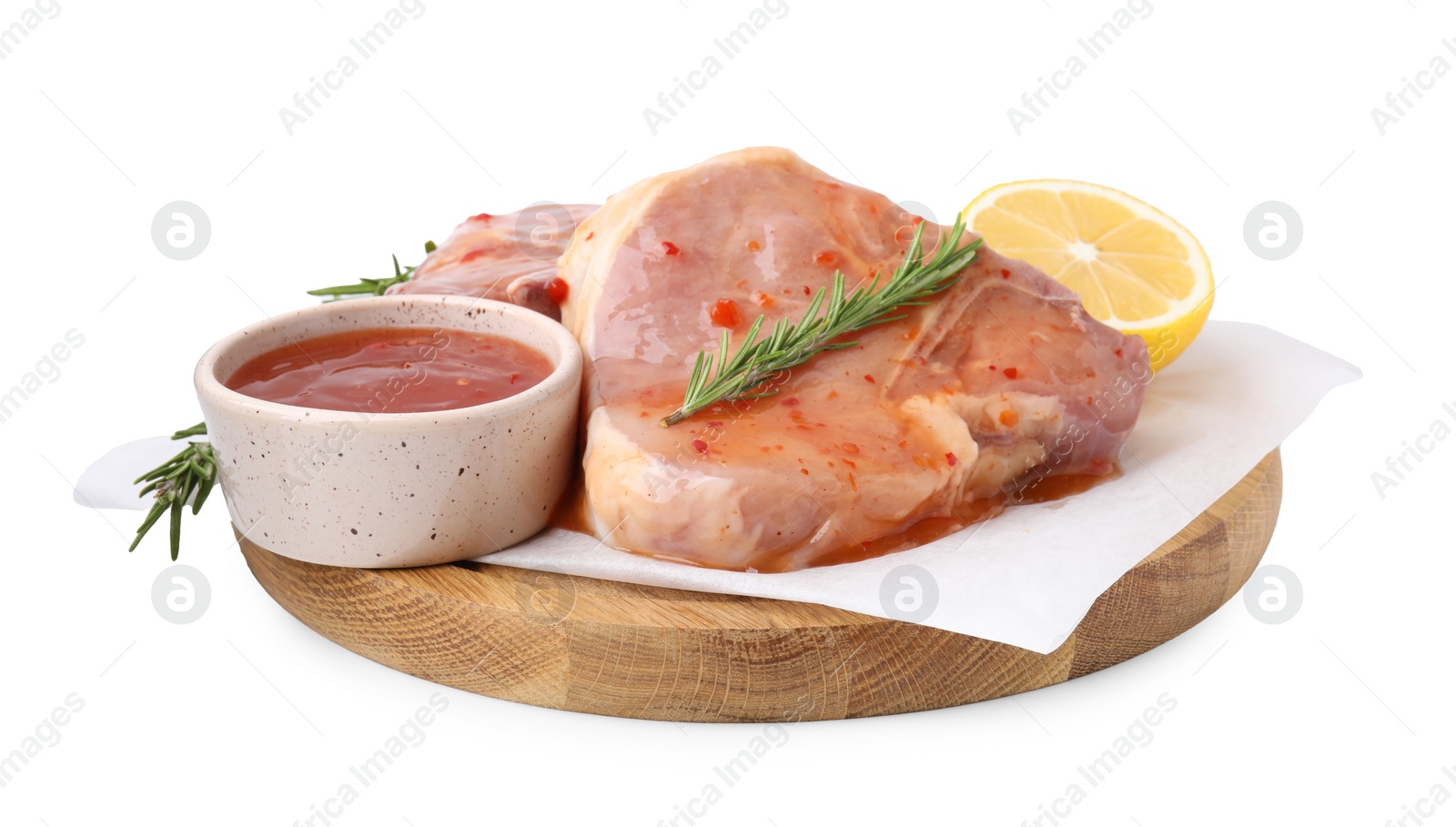 Photo of Board with raw meat, marinade, lemon and rosemary isolated on white