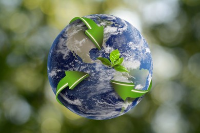 Recycling concept. Earth planet with green arrows and leaves on blurred background, illustration