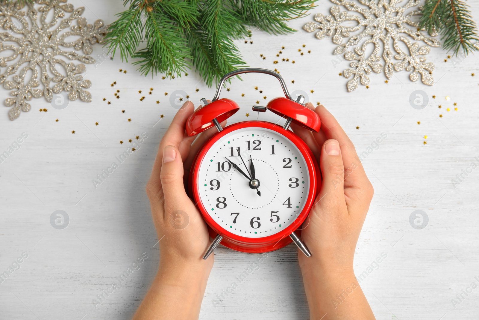 Photo of Woman with alarm clock at table, top view. Christmas countdown