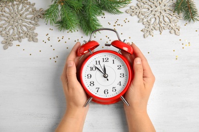 Woman with alarm clock at table, top view. Christmas countdown